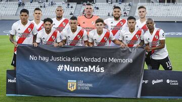 BUENOS AIRES, ARGENTINA - MARCH 28:  Players of River Plate pose holding a flag that reads &quot;No justice without truth and remembrance, Never Again&quot; as Argentina commemorates 45 years after the last coup prior a match as part of Copa de la Liga Profesional 2021 between River Plate and Racing Club at Estadio Monumental Antonio Vespucio Liberti on March 28, 2021 in Buenos Aires, Argentina. (Photo by Marcelo Endelli/Getty Images)