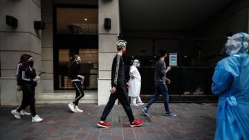 AME3622. BUENOS AIRES (ARGENTINA), 20/07/2020.- Personas con tapabocas pasan frente a una clínica este lunes el primer día de la flexibilización de la cuarentena obligatoria por el COVID-19 en Buenos Aires (Argentina). La ciudad de Buenos Aires y su populosa área metropolitana (AMBA), junto a otras localidades con alta circulación de coronavirus, entraron este lunes en una etapa de la cuarentena más flexible, que contempla la apertura progresiva de actividades comerciales y habilita las salidas recreativas, todo sujeto a protocolos. EFE/Juan Ignacio Roncoroni