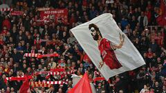 Liverpool fans waves flags in the crowd ahead of the English Premier League football match between Liverpool and Tottenham Hotspur at Anfield in Liverpool, north west England on May 7, 2022. (Photo by Paul ELLIS / AFP) / RESTRICTED TO EDITORIAL USE. No use with unauthorized audio, video, data, fixture lists, club/league logos or 'live' services. Online in-match use limited to 120 images. An additional 40 images may be used in extra time. No video emulation. Social media in-match use limited to 120 images. An additional 40 images may be used in extra time. No use in betting publications, games or single club/league/player publications. / 