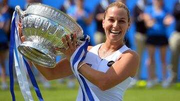 Slovakia's Dominika Cibulkova celebrates with the trophy after winning her women's singles Final match against Czech Republic's Karolina Pliskova at the WTA Eastbourne International tennis tournament in Eastbourne, southern England on June 25, 2016. / AFP PHOTO / GLYN KIRK
