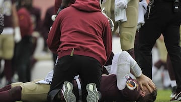 Washington Redskins quarterback Alex Smith, bottom, reacts after an injury during the second half of an NFL football game against the Houston Texans, Sunday, Nov. 18, 2018, in Landover, Md. (AP Photo/Mark Tenally)