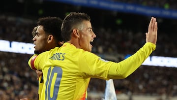 Colombia's forward #07 Luis Diaz (L) celebrates with teammate midfielder #10 James Rodriguez after scoring his team's first goal during the 2026 FIFA World Cup South American qualifiers football match between Argentina and Colombia at the Mas Monumental stadium in Buenos Aires, on June 10, 2025. (Photo by Alejandro PAGNI / AFP)