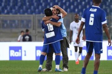 ROM01. ROMA (ITALIA), 12/10/2016.- Un hombre entra al campo de juego y saluda a la leyenda del fútbol argentino Diego Armando Maradona (i) durante un partido de beneficencia 'Partido de la Paz- Unidos por la Paz' hoy, miércoles 12 de octubre de 2016, que es promovido por la fundación Escuelas del Encuentro, una organización impulsada por el papa Francisco, en el estadio Olímpico en Roma (Italia). 