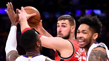 Jan 1, 2017; Los Angeles, CA, USA; Los Angeles Lakers forward Thomas Robinson (15) and Los Angeles Lakers forward Brandon Ingram (14) guard Toronto Raptors center Jonas Valanciunas (17) as he looks to pass in the first half of the game at Staples Center. Mandatory Credit: Jayne Kamin-Oncea-USA TODAY Sports
