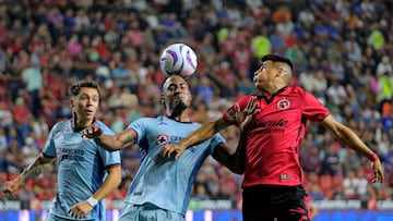 Tijuana's Argentine midfielder Silvio Martinez (R) fights for the ball with Cruz Azul's Colombian defender Willer Ditta (C) during the Mexican Apertura tournament football match between Tijuana and Cruz Azul at Caliente stadium in Tijuana, Baja California, Mexico, on July 14, 2023. (Photo by Guillermo Arias / AFP)