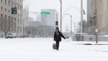 Un peatón arrastra una maleta con ruedas por las calles del centro de la ciudad cubiertas de nieve, mientras el clima invernal continúa cubriendo St. Louis, Misuri, Estados Unidos, el 24 de enero de 2026.