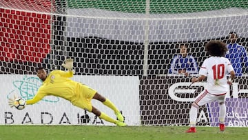 Oman's goalkeeper Fayez al-Rusheidi (L) stops the ball after a penalty by the UAE's player Omar Abdulrahman during the Gulf Cup of Nations 2017 final football match between Oman and the UAE at the Sheikh Jaber al-Ahmad Stadium in Kuwait City on