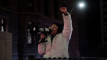 A demonstrator holds up her fist at a protest for Amir Locke, a Black man who was shot and killed by Minneapolis police's SWAT team, in Minneapolis, Minnesota.