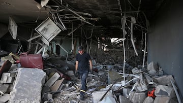 A rescuer inspects inside of an apartment building damaged during Russian missile strikes, amid Russia's attack on Ukraine, in Kyiv, Ukraine July 8, 2024. REUTERS/Viacheslav Ratynskyi