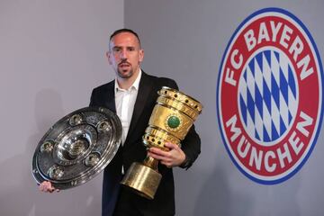 Franck Ribery poses for a picture with the Bundesliga trophy and the DFB cup on May 28, 2019 in Munich, Germany.