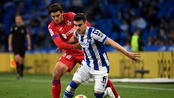 Getafe's Spanish midfielder Gonzalo Villar (L) vies with Real Sociedad's Spanish forward Ander Barrenetxea during the Spanish league football match between Real Sociedad and Getafe CF at the Reale Arena stadium in San Sebastian on April 8, 2023. (Photo by ANDER GILLENEA / AFP) (Photo by ANDER GILLENEA/AFP via Getty Images)