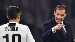 Juventus' Italian coach Massimiliano Allegri (R) speaks with Juventus' Argentine forward Paulo Dybala during the Italian Serie A football match between Napoli and Juventus on March 3, 2019, at the San Paolo Stadium in Naples.