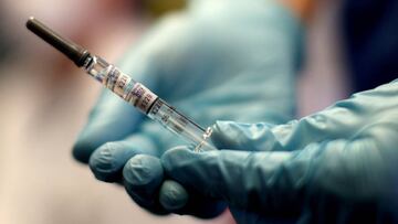 A healthcare worker of the free influenza vaccination programme holds a flu vaccine inside a tram, as the global spread of the the coronavirus disease (COVID-19) continues, in Vienna, Austria, October 1, 2020. REUTERS/Lisi Niesner