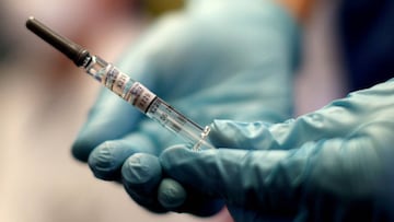 A healthcare worker of the free influenza vaccination programme holds a flu vaccine inside a tram, as the global spread of the the coronavirus disease (COVID-19) continues, in Vienna, Austria, October 1, 2020. REUTERS/Lisi Niesner