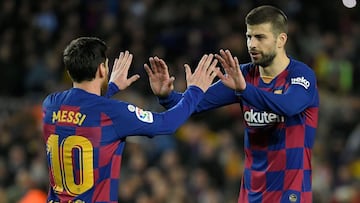 Lionel Messi celebrates with Barcelona&#039;s Spanish defender Gerard Piqu&eacute;. 