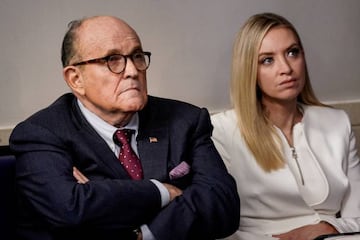 Rudy Giuliani, former New York City Mayor and personal attorney to US President Donald Trump, listens next to White House press secretary Kayleigh McEnany as Trump speaks to reporters.