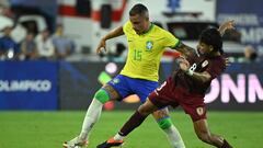 Brazil's midfielder Bruno Gomes (L) and Venezuela's midfielder Telasco Segovia fight for the ball during the Venezuela 2024 CONMEBOL Pre-Olympic Tournament Group A football match between Venezuela and Brazil at the Brigido Iriarte stadium in Caracas, on February 1, 2024. (Photo by Federico Parra / AFP)