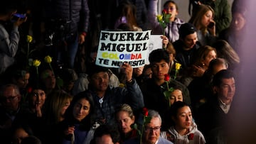 A man holds up a placard that reads "Come on Miguel, Colombia needs you", as people attend a Mass outside the Santa Fe Foundation hospital where Colombian Senator Miguel Uribe Turbay is being treated after he was shot during a campaign event, in Bogota, Colombia, June 11, 2025. REUTERS/Luisa Gonzalez