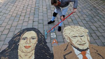 Kosovo artist Alkent Pozhegu works on mosaic made of grains showing portraits of Democratic presidential nominee U.S. Vice President Kamala Harris and Republican presidential nominee and former U.S. President Donald Trump, in Gjakova, Kosovo November 5, 2024. REUTERS/Valdrin Xhemaj