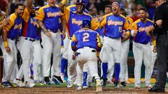 Mar 18, 2023; Miami, Florida, USA; Venezuela first baseman Luis Arraez (2) celebrates with teammates after hitting a home run during the seventh inning against the USA at LoanDepot Park. Mandatory Credit: Sam Navarro-USA TODAY Sports