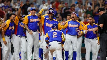 Mar 18, 2023; Miami, Florida, USA; Venezuela first baseman Luis Arraez (2) celebrates with teammates after hitting a home run during the seventh inning against the USA at LoanDepot Park. Mandatory Credit: Sam Navarro-USA TODAY Sports