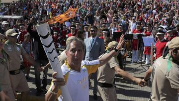 Jose Roberto Correa da Silva, a local teacher, carries the Olympic torch in the streets of Sao Luiz do Paraitinga, Brazil, nine days before the start of the Rio 2016 Olympic Games, July 27, 2016. REUTERS/Roosevelt Cassio