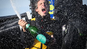 French skipper Charlie Dalin celebrates with champagne after arriving at the harbour after winning the 10th edition of the Vendee Globe around the world monohull solo sailing race, in Les Sables-d'Olonne, western France, early on January 14, 2025. French skipper Charlie Dalin won the round-the-world Vendee Globe race on January 14, finishing off Brittany in a record time of 64 days, 19 hours, 22 minutes and 49 seconds. (Photo by Loic VENANCE / AFP)