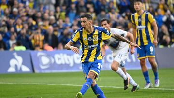 (FILES) Rosario Central's forward #11 Angel di Maria kicks the ball to score a penalty goal during the Argentine Professional Football League 2025 Clausura Tournament between Rosario Central and Godoy Cruz at the Gigantes de Arroyito Stadium in Rosario, Argentina, on July 12, 2025. Backed by a weak peso under the ultra-liberal policies of President Javier Milei, Argentine football has regained momentum and now generates millions. (Photo by Marcelo Manera / AFP)