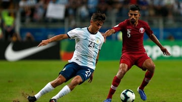 Qatar&#039;s Tareq Salman (R) and Argentina&#039;s Paulo Dybala vie for the ball during their Copa America football tournament group match at the Gremio Arena in Porto Alegre, Brazil, on June 23, 2019. (Photo by Jeferson Guareze / AFP)