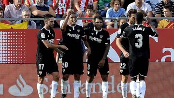 Sevilla's Colombian midfielder Luis Muriel (2L) is congratulated by his teammates after scoring during the Spanish league football match Girona FC vs Sevilla FC at at the Municipal de Montilivi stadium in Girona on September 17, 2017. / AFP PHOTO / Josep LAGO
