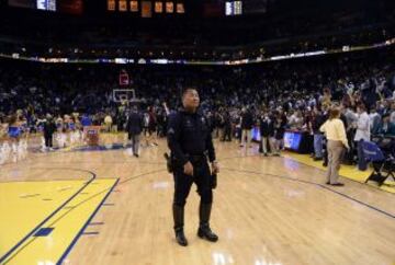 Un policía armado camina por la cancha del Oracle Arena en Oakland (EE.UU.), tras el partido de la NBA que enfrentó a San Antonio Spurs y a Golden State Warriors.