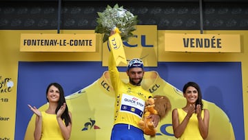 Colombia's Fernando Gaviria, wearing the overall leader's yellow jersey, celebrates on the podium after winning the first stage of the 105th edition of the Tour de France cycling race between Noirmoutier-en-l'ile and Fontenay-le Comte, western France, on July 7, 2018. (Photo by Marco BERTORELLO / AFP) (Photo credit should read MARCO BERTORELLO/AFP via Getty Images)