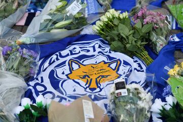 A flag showing the Leicester City Football Club's Fox logo with a message of thanks is seen in a growing pile of tributes outside Leicester City Football Club's King Power Stadium in Leicester