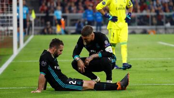 Soccer Football - Champions League Semi Final First Leg - Bayern Munich vs Real Madrid - Allianz Arena, Munich, Germany - April 25, 2018 Real Madrid's Dani Carvajal lies injured with Sergio Ramos REUTERS/Kai Pfaffenbach