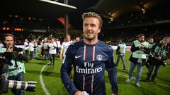(FILES) Picture taken on May 12, 2013 shows PSG midfielder David Beckham celebrating after Paris Saint-Germain won the French L1 title at the Gerland stadium in Lyon. David Beckham is to retire from professional football at the end of the season, his representative announced on May 16, 2013.  
AFP PHOTO/PHILIPPE DESMAZES