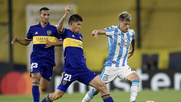 Jorman Campuzano of Argentina&#039;s Boca Juniors, left, challenges Hector Fertoli of Argentina&#039;s Racing Club during a Copa Libertadores quarterfinal second leg soccer match at the Bombonera stadium in Buenos Aires, Argentina, Wednesday, Dec. 23, 2020. (Juan Mabromata/Pool via AP)