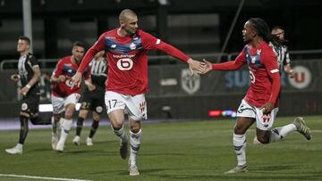 Lille's Burak Yilmaz, left, celebrates with Lille's Renato Sanches after scoring the second goal from the penalty spot during the French League One soccer match between Angers and Lille at the Raymond Kopa Stadium in Angers, France, Sunday May 2