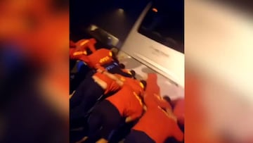 Rugby players form scrum to push broken-down team bus