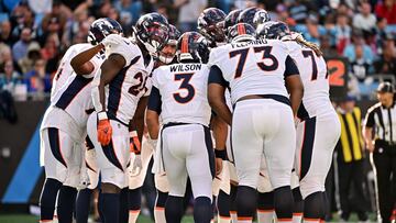 CHARLOTTE, NORTH CAROLINA - NOVEMBER 27: Russell Wilson #3 of the Denver Broncos calls a play in the huddle during the first half against the Carolina Panthers at Bank of America Stadium on November 27, 2022 in Charlotte, North Carolina.   Grant Halverson/Getty Images/AFP (Photo by GRANT HALVERSON / GETTY IMAGES NORTH AMERICA / Getty Images via AFP)