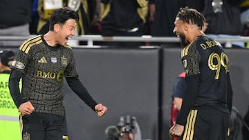 LAFC's French forward #99 Denis Bouanga (R) celebrates after scoring this team second goal with teammate South Korean forward #07 Son Heung-min during the Major League Soccer opening match between Los Angeles Football Club and Inter Miami CF at the LA Memorial Coliseum in Los Angeles, on February 21, 2026. (Photo by Frederic J. Brown / AFP)
