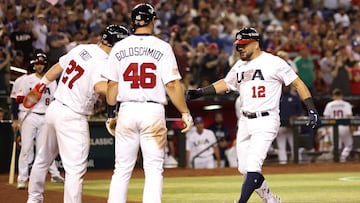 PHOENIX, ARIZONA - MARCH 11: Kyle Schwarber #12 of Team USA is congratulated by Mike Trout #27 and Paul Goldschmidt #46 after hitting a three-run home run against Team Great Britain during the fourth inning of the World Baseball Classic Pool C game at Chase Field on March 11, 2023 in Phoenix, Arizona.   Christian Petersen/Getty Images/AFP (Photo by Christian Petersen / GETTY IMAGES NORTH AMERICA / Getty Images via AFP)