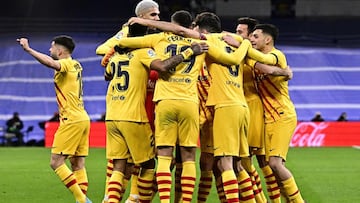 Barcelona's players celebrate after scoring a goal during the Spanish League football match between Real Madrid CF and FC Barcelona at the Santiago Bernabeu stadium in Madrid on March 20, 2022. (Photo by JAVIER SORIANO / AFP)