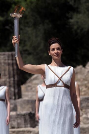 OLYMPIA, GREECE -  20 APRIL:  Actress Katerina Lechou acting the high pristess holds the Olympic Torch at the Ancient Stadium during the Rehearsal for the Lighting Ceremony of the Olympic Flame at Ancient Olympia on April 20, 2016 in Olympia, Greece.  (Photo by Milos Bicanski/Getty Images)