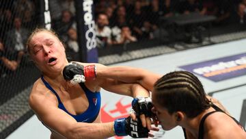 LAS VEGAS, NV - DECEMBER 30: (R-L) Amanda Nunes of Brazil punches Ronda Rousey in their UFC women's bantamweight championship bout during the UFC 207 event at T-Mobile Arena on December 30, 2016 in Las Vegas, Nevada. (Photo by Josh Hedges/Zuffa LLC/Zuffa LLC via Getty Images)