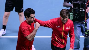 Spain's Jaume Munar Clar celebrates with Spain's captain David Ferrer after winning against Czech Republic's Jiri Lehecka during the Davis Cup men's singles quarter finals tennis match, at the Super Tennis Arena, in Bologna, northen Italy, on November 20, 2025. (Photo by Tiziana FABI / AFP)