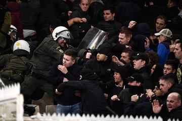 AEK Athens fans jumped onto the pitch and launched flares at the Ajax fans in the Champions League game in Greece on Tuesday night, causing police to intervene.