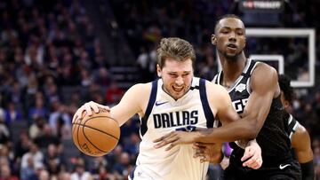 SACRAMENTO, CALIFORNIA - JANUARY 15: Luka Doncic #77 of the Dallas Mavericks is fouled by Harry Giles III #20 of the Sacramento Kings at Golden 1 Center on January 15, 2020 in Sacramento, California. NOTE TO USER: User expressly acknowledges and agrees that, by downloading and or using this photograph, User is consenting to the terms and conditions of the Getty Images License Agreement.   Ezra Shaw/Getty Images/AFP
 == FOR NEWSPAPERS, INTERNET, TELCOS &amp; TELEVISION USE ONLY ==