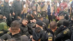 Police sit while officials from Colombia's human rights ombudsman speak with demonstrators who, according to authorities, belong to rural and Indigenous communities and are demanding that oil company Emerald Energy build roads in San Vicente del Caguan, Colombia March 2, 2023. Colombian Ombudsman Office/Handout via REUTERS ATTENTION EDITORS - THIS IMAGE WAS PROVIDED BY A THIRD PARTY. MANDATORY CREDIT. NO RESALES. NO ARCHIVES