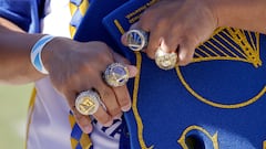 A fan shows off replica championship rings outside the Chase Center