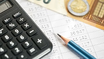 Calculator, money and pencil close-up on a blurred background, the concept of tax calculations and finance.